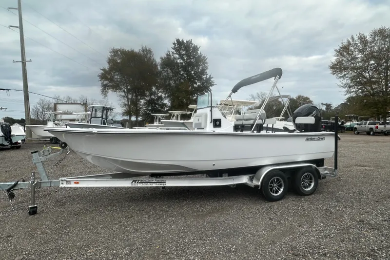 Slide: The Image of 2026 Action Craft 22 Bay boat on trailer, parked outdoors under cloudy sky. - 3