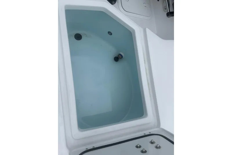 Slide: The Image of Livewell on 2026 Action Craft 22 Bay boat, filled with water. - 30