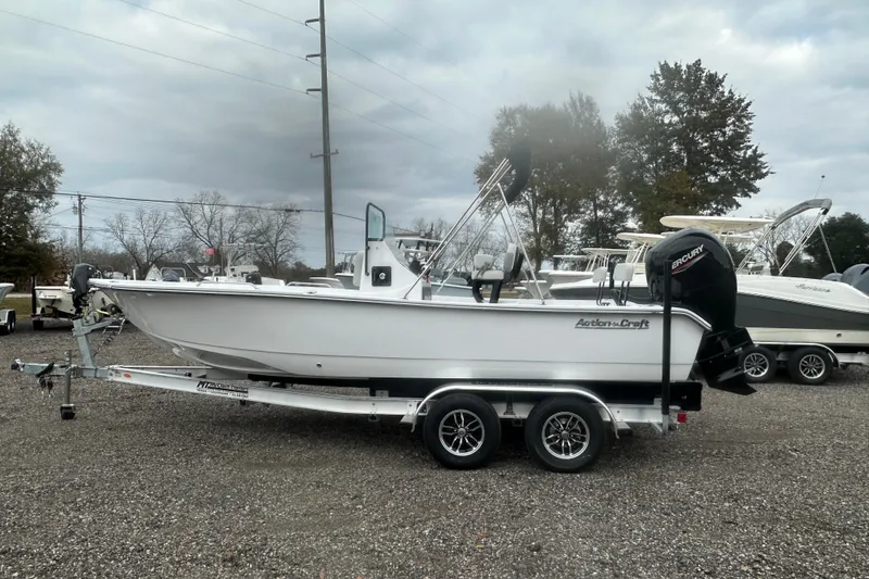 Slide: The Image of 2026 Action Craft 22 Bay boat on trailer, parked outdoors under cloudy sky. - 4