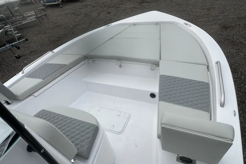 Slide: The Image of 2026 Action Craft 22 Bay boat interior with gray cushioned seating and storage compartments. - 40