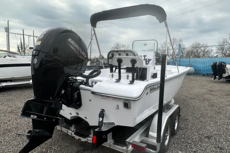 Slide: The Image of 2026 Action Craft 22 Bay boat with Mercury engine on trailer, parked outdoors. - 7