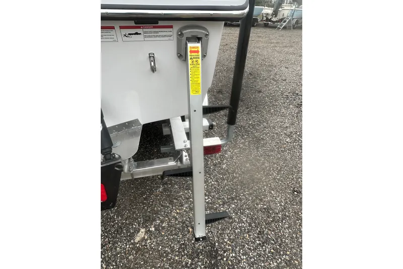 Slide: The Image of 2026 Action Craft 22 Bay boat trailer with safety warning label. - 8