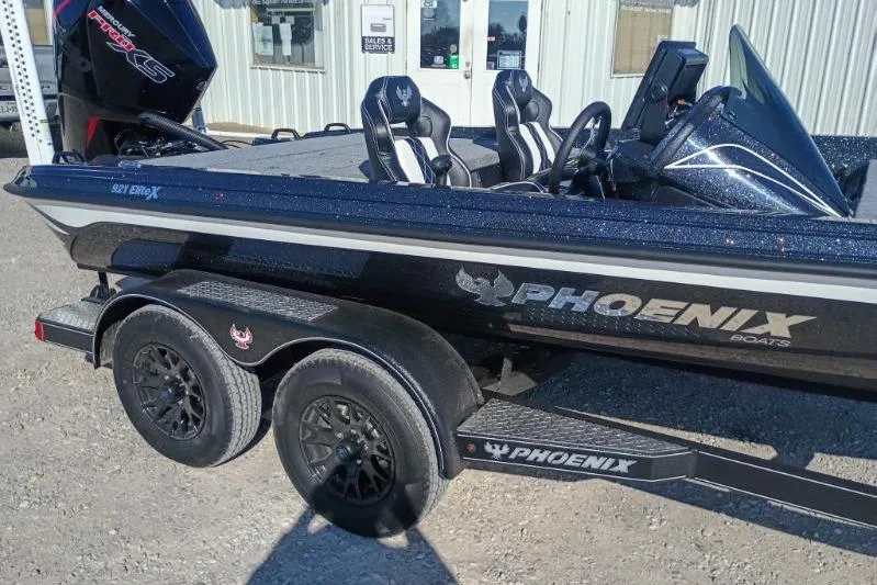 Slide: The Image of 2026 Phoenix 921 Elite X boat on trailer, featuring sleek design and dual axles. - 3