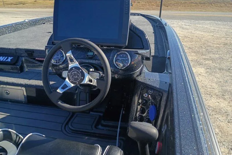 Slide: The Image of 2026 Phoenix 921 Elite X boat dashboard with steering wheel and digital display. - 4