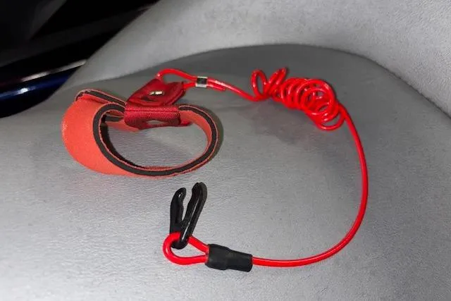 Slide: The Image of Red safety lanyard for 2013 Yamaha WaveRunner VX Cruiser on gray seat. - 12
