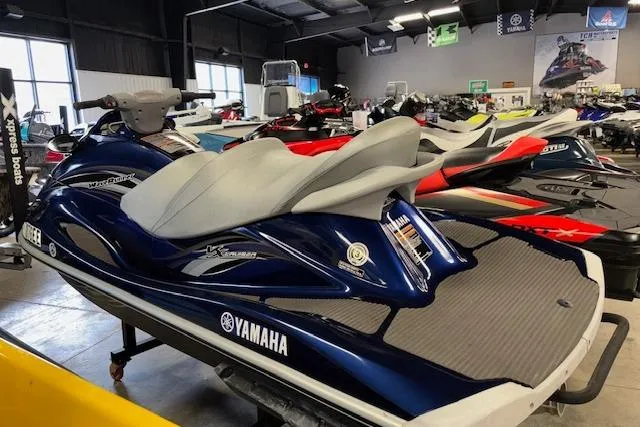 Slide: The Image of 2013 Yamaha WaveRunner VX Cruiser in showroom, blue and gray design, side view. - 7