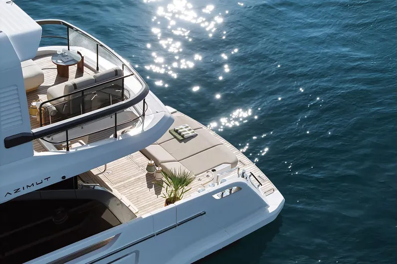Slide: The Image of Manufacturer Provided Image: Luxurious 2025 Azimut Fly 62 yacht on sparkling blue water, featuring elegant deck seating. - 2