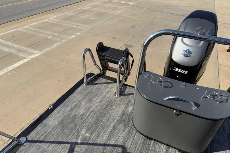 Slide: The Image of 2026 Avalon Excalibur LTD Quad Lounge boat with Suzuki 350 engine on a dock. - 19