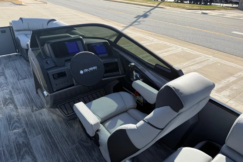 Slide: The Image of 2026 Avalon Excalibur LTD Quad Lounge Windshield boat interior with modern dashboard and seating. - 29