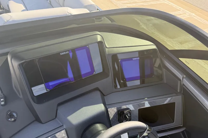Slide: The Image of 2026 Avalon Excalibur LTD Quad Lounge dashboard with dual Simrad displays. - 34