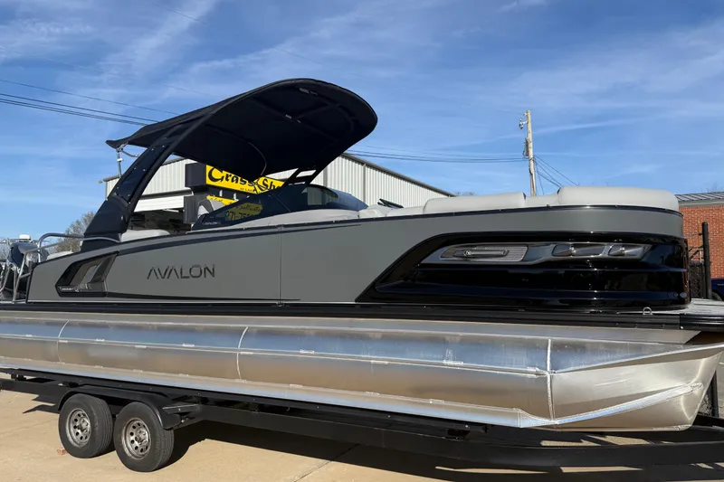 Slide: The Image of 2026 Avalon Excalibur LTD Quad Lounge Windshield pontoon boat on trailer, side view. - 42