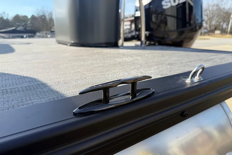 Slide: The Image of 2026 Avalon Excalibur LTD Quad Lounge Windshield boat deck with cleat and railing. - 44