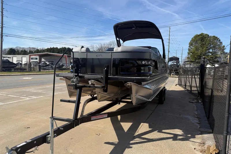 Slide: The Image of 2026 Avalon Excalibur LTD Quad Lounge Windshield boat on trailer, parked outdoors. - 6