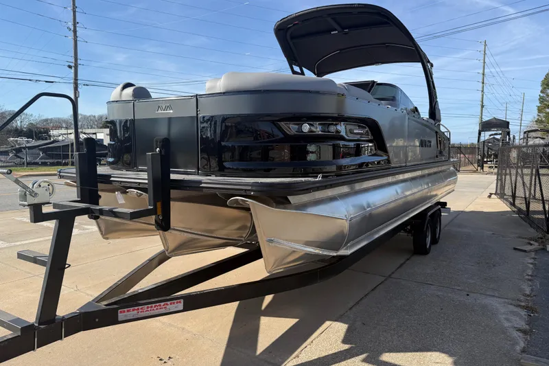 Slide: The Image of 2026 Avalon Excalibur LTD Quad Lounge Windshield pontoon boat on trailer. - 7
