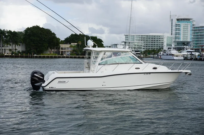 Slide: The Image of 2015 Boston Whaler 345 Conquest cruising on ocean near city skyline. - 12