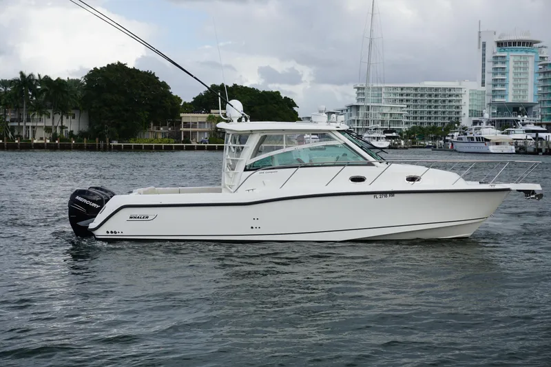 Slide: The Image of 2015 Boston Whaler 345 Conquest cruising on clear blue ocean waters. - 13