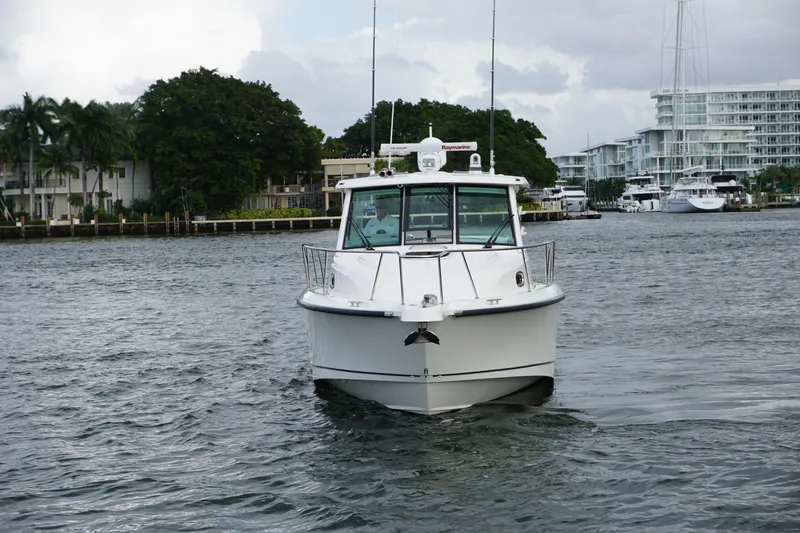 Slide: The Image of 2015 Boston Whaler 345 Conquest cabin interior with cozy seating and modern amenities. - 19