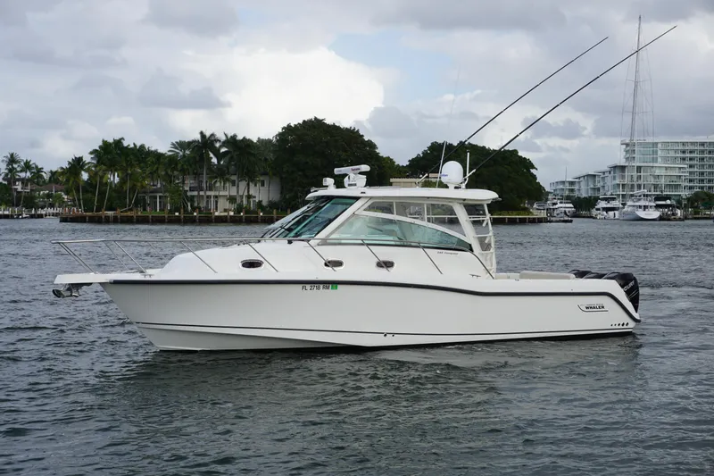 Slide: The Image of 2015 Boston Whaler 345 Conquest interior kitchen with microwave, sink, and seating area. - 21