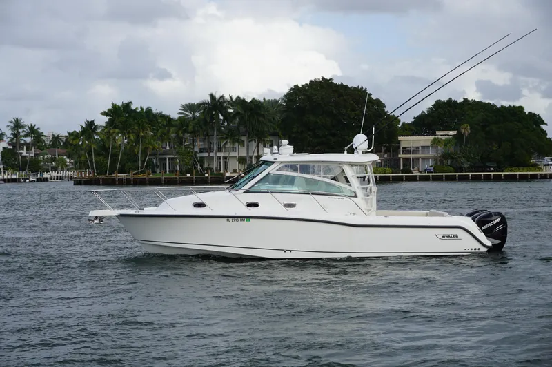 Slide: The Image of 2015 Boston Whaler 345 Conquest boat on clear blue water, sunny day. - 3