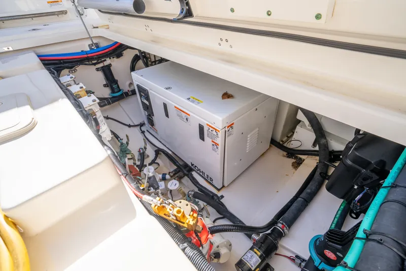 Slide: The Image of 2015 Boston Whaler 345 Conquest engine compartment with Kohler generator and wiring. - 30