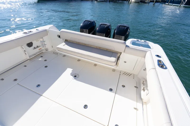 Slide: The Image of 2015 Boston Whaler 345 Conquest boat deck with triple outboard engines. - 31