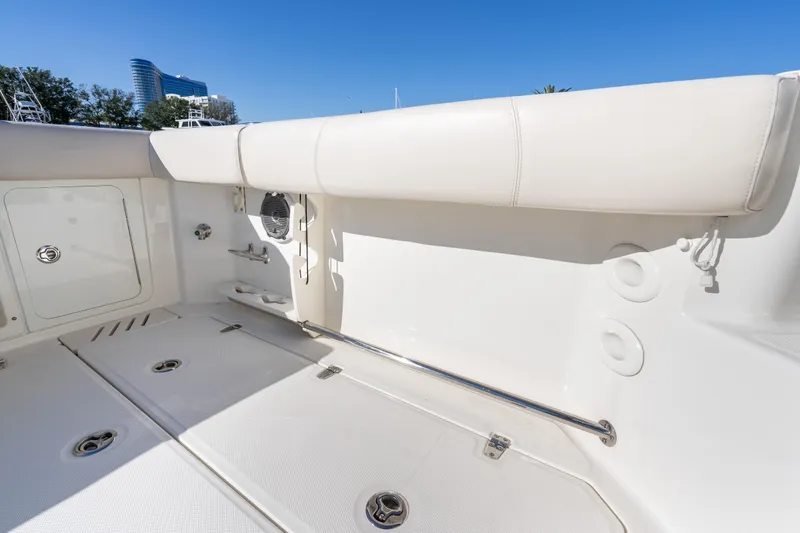 Slide: The Image of 2015 Boston Whaler 345 Conquest boat interior with white seating and storage compartments. - 35