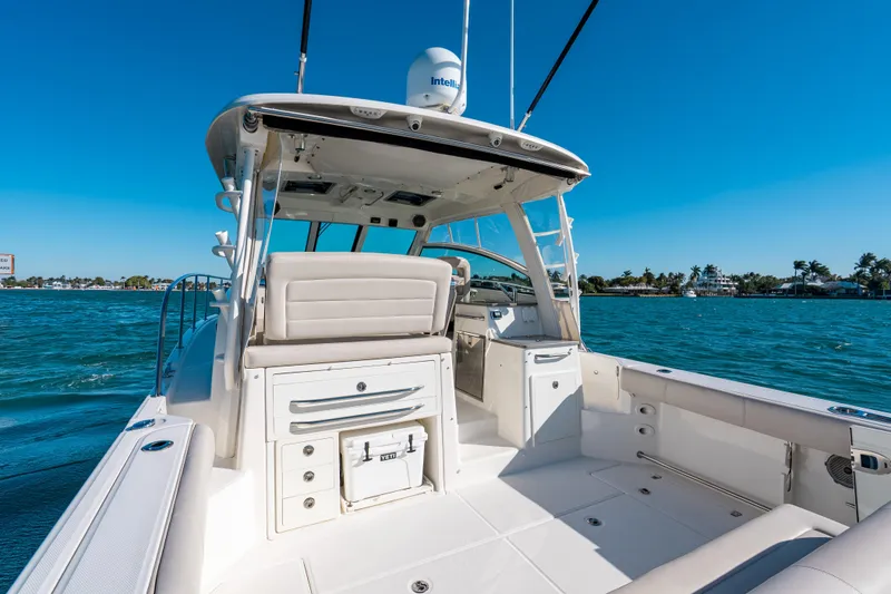 Slide: The Image of 2015 Boston Whaler 345 Conquest boat on clear blue water, sunny day. - 38
