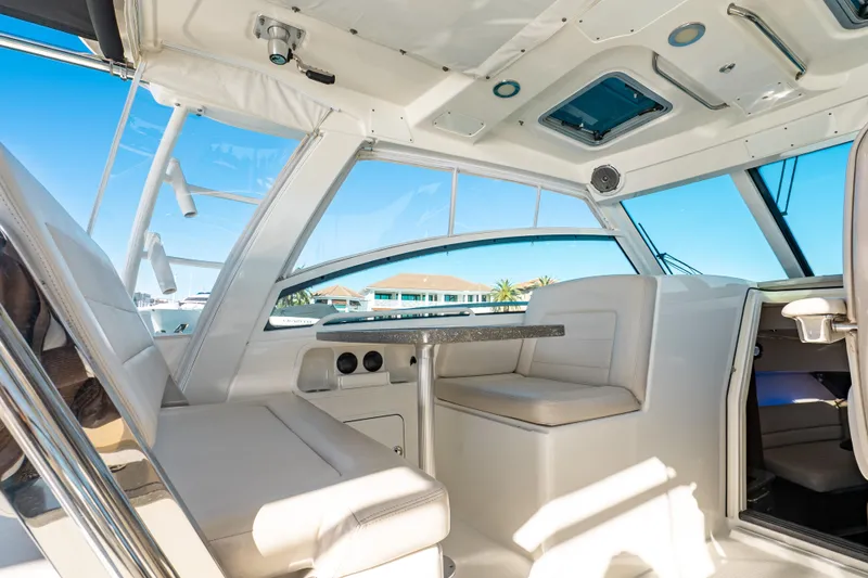 Slide: The Image of Interior of 2015 Boston Whaler 345 Conquest boat, featuring seating and table. - 42