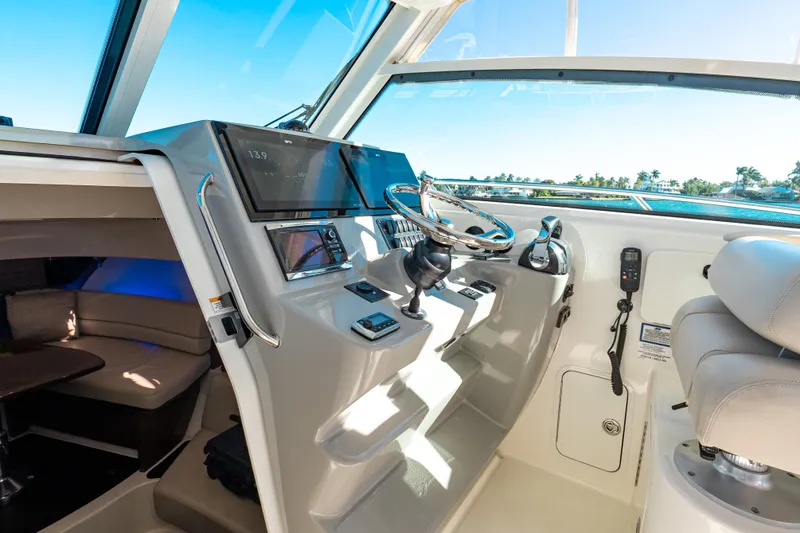 Slide: The Image of 2015 Boston Whaler 345 Conquest helm with modern controls and spacious cabin interior. - 45