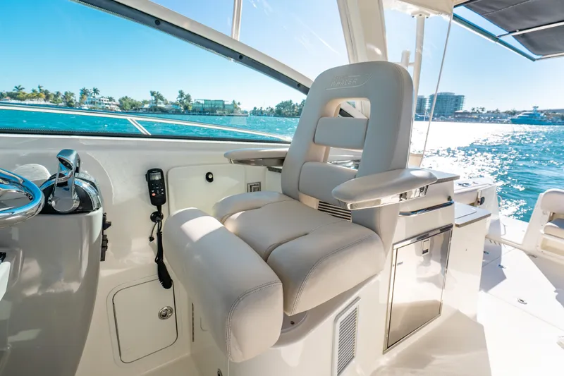 Slide: The Image of Captain's seat on 2015 Boston Whaler 345 Conquest, overlooking sunny ocean view. - 46