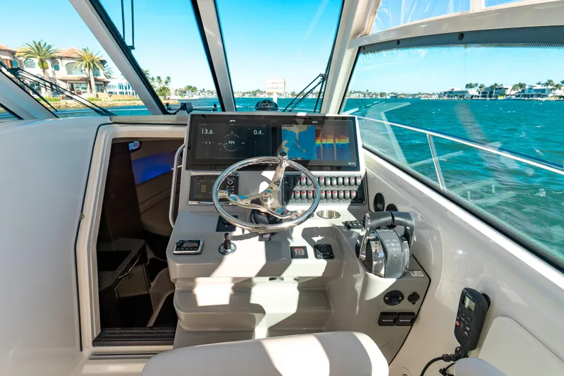 Slide: The Image of 2015 Boston Whaler 345 Conquest helm with navigation screens and ocean view. - 47