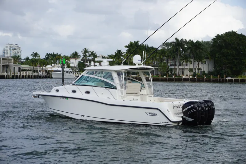 Slide: The Image of 2015 Boston Whaler 345 Conquest boat with triple Mercury engines on the water. - 5