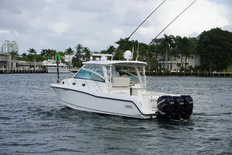 Slide: The Image of 2015 Boston Whaler 345 Conquest boat on water, rear view, named "Private Island." - 6