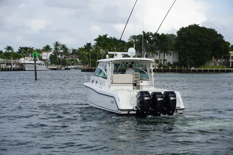 Slide: The Image of 2015 Boston Whaler 345 Conquest with four powerful outboard engines on the water. - 7