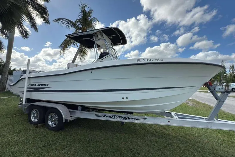 The Image of 2003 Hydra-Sports Vector 2400 CC boat on trailer, parked on grass under palm trees. - 0