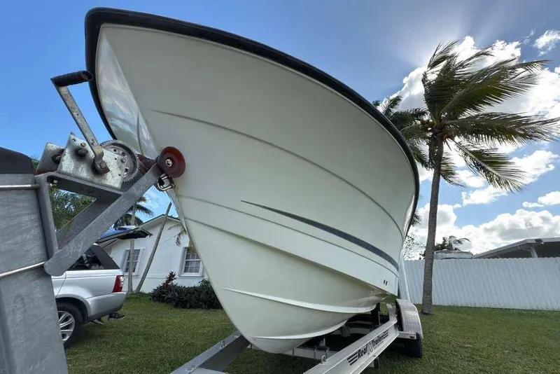 Slide: The Image of 2003 Hydra-Sports Vector 2400 CC boat on trailer, sunny day, palm trees in background. - 11