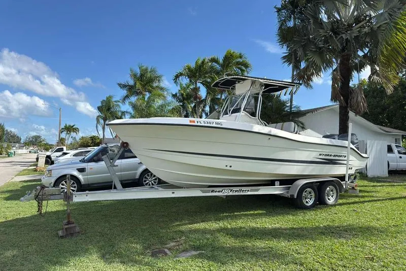Slide: The Image of 2003 Hydra-Sports Vector 2400 CC boat on trailer, parked near palm trees. - 14