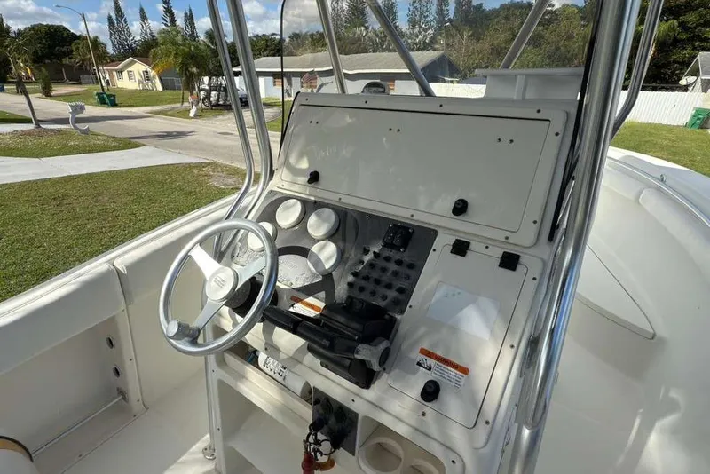 Slide: The Image of 2003 Hydra-Sports Vector 2400 CC boat console with steering wheel and controls. - 27