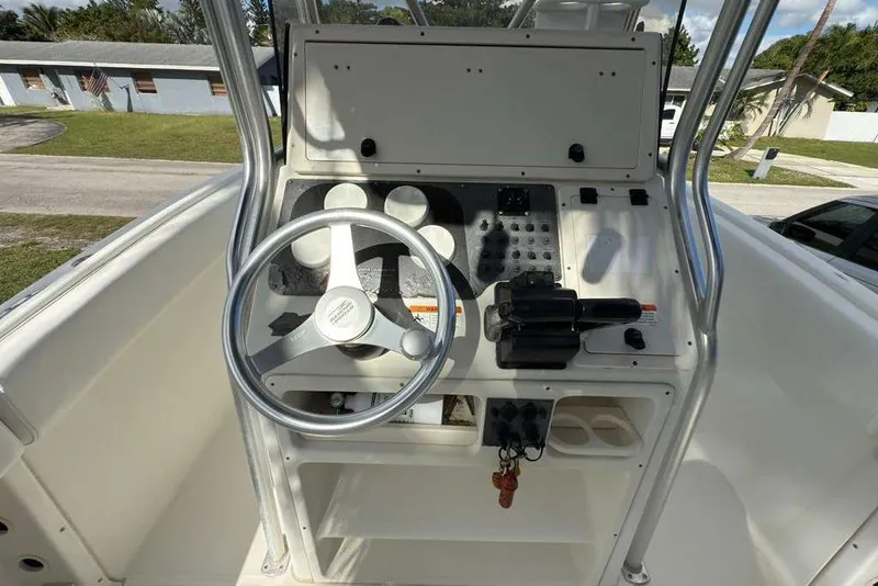 Slide: The Image of 2003 Hydra-Sports Vector 2400 CC boat console with steering wheel and controls. - 30