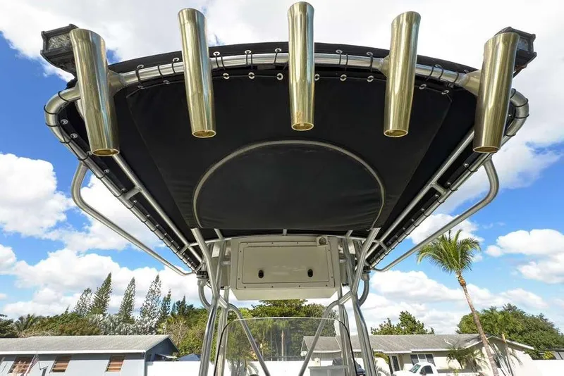 Slide: The Image of 2003 Hydra-Sports Vector 2400 CC boat with rod holders and T-top against blue sky. - 31