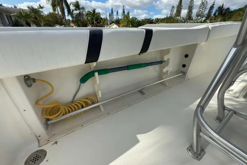 Slide: The Image of 2003 Hydra-Sports Vector 2400 CC boat interior with storage compartment and coiled hose. - 35