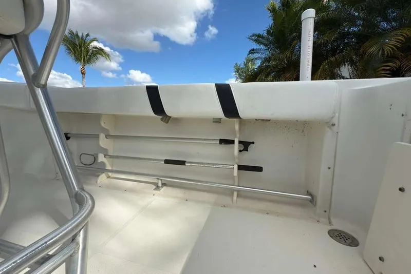 Slide: The Image of 2003 Hydra-Sports Vector 2400 CC boat interior with rod holders and clear sky background. - 36