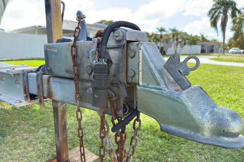 Slide: The Image of Trailer hitch of a 2003 Hydra-Sports Vector 2400 CC, with chains and wiring, on grass. - 43