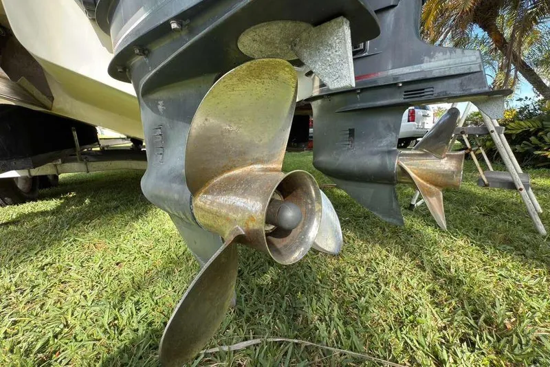 Slide: The Image of Close-up of 2003 Hydra-Sports Vector 2400 CC boat propellers on grass. - 48