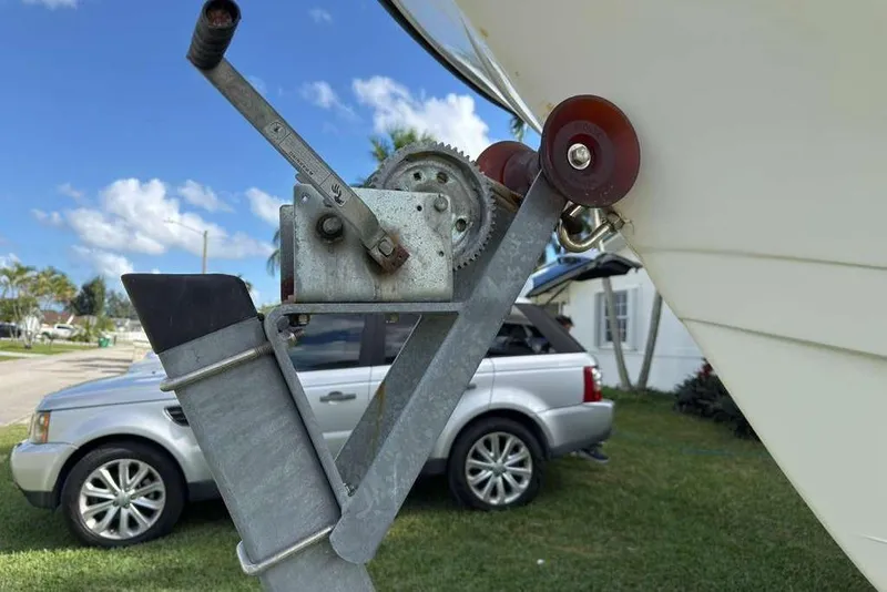 Slide: The Image of Boat trailer winch with a 2003 Hydra-Sports Vector 2400 CC, parked near a silver SUV. - 50