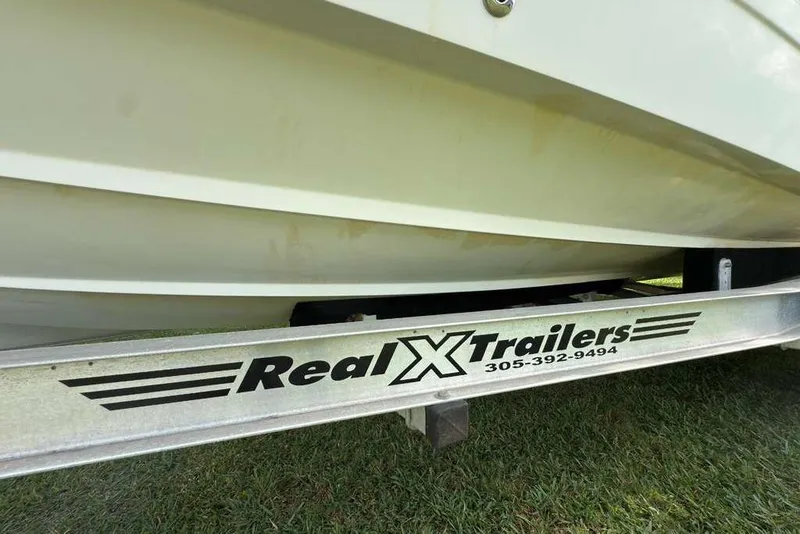 Slide: The Image of 2003 Hydra-Sports Vector 2400 CC on Real X Trailers, parked on grass. - 51