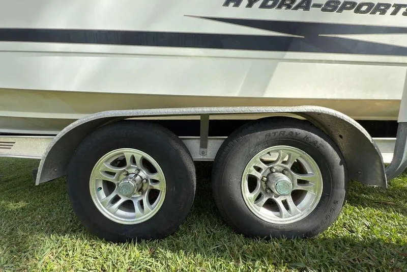 Slide: The Image of 2003 Hydra-Sports Vector 2400 CC trailer wheels on grass. - 53