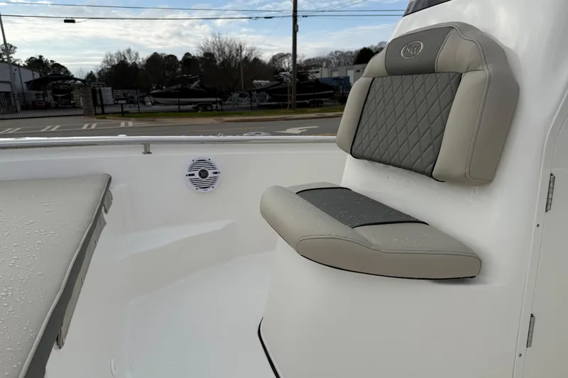 Slide: The Image of 2026 Key West 189 FS boat interior with cushioned seating and speaker. - 12