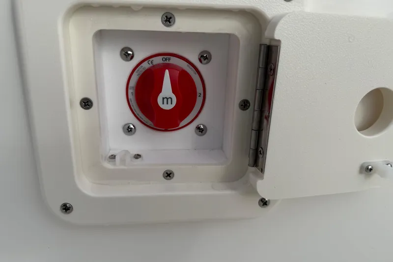Slide: The Image of Battery switch on 2026 Key West 189 FS boat, red dial in white compartment. - 20