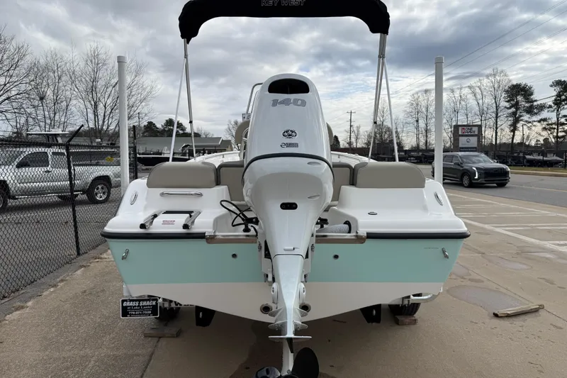 Slide: The Image of 2026 Key West 189 FS boat with outboard motor, parked outdoors on a cloudy day. - 5